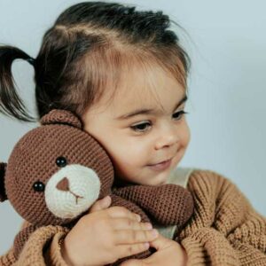 Baby Girl holding a Toy - Image