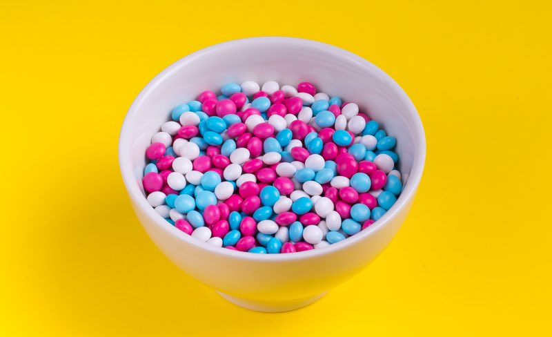 bright colored candies in a white bowl