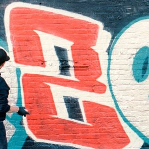 Man drawing graffiti on the wall