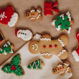 Gingerbread man with assorted Christmas cookies