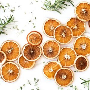Slices of orange with herbs scattered on a table