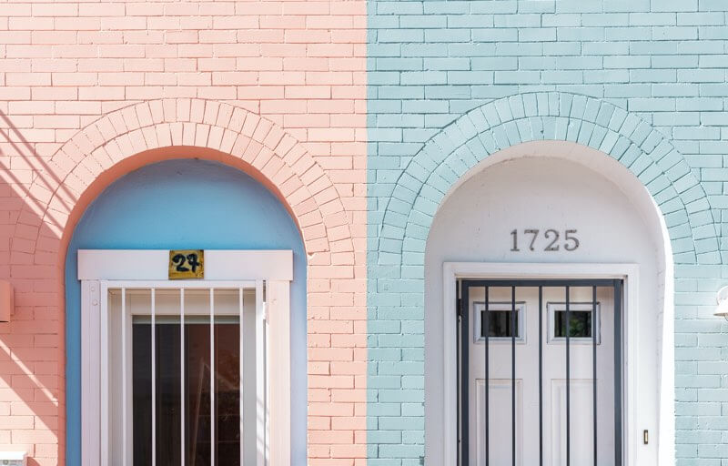 Two differently colored pastel walls with doors