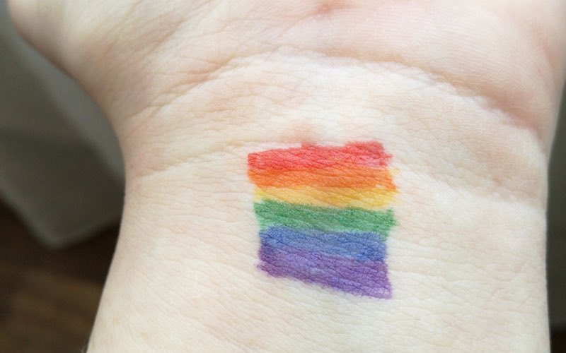 LGBTQ+ flag colors painted on wrist