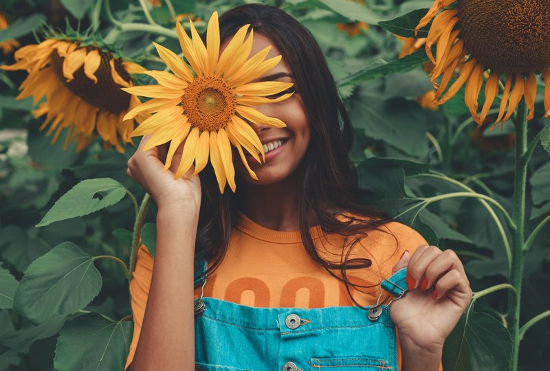 Girl with sunflower plants