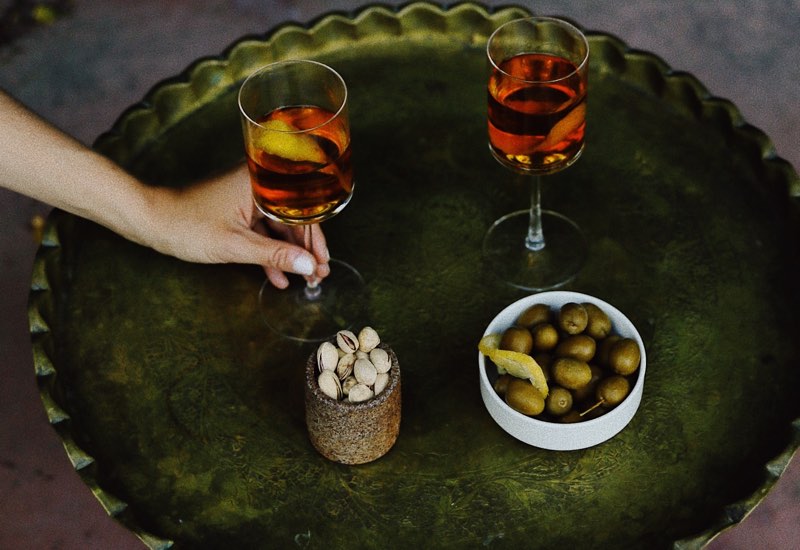 Wine served with olives and pistachio nuts