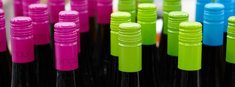 Colorful cap covers of wine bottles
