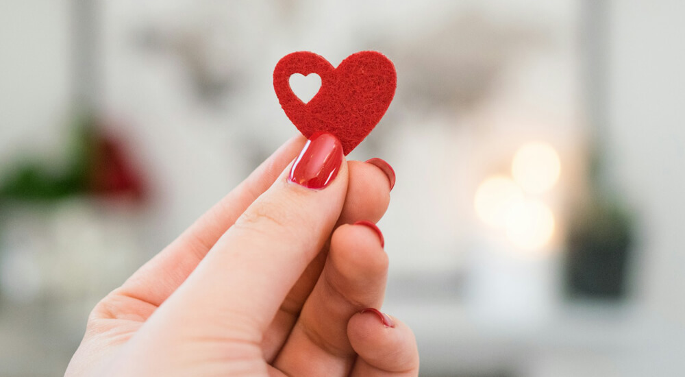 Woman holding red Heart