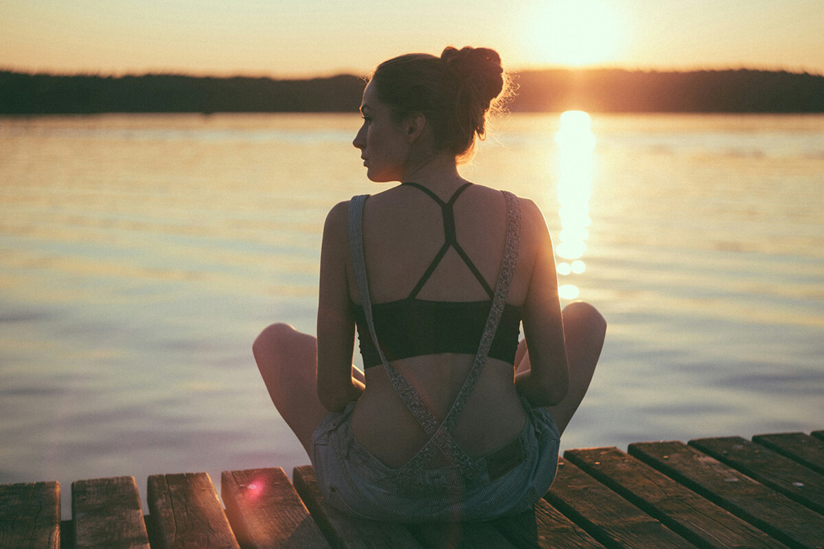 Woman relaxing at Summer sunset